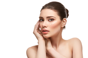 Image showing girl applying moisturizing cream isolated on white