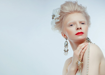 Image showing beautiful albino girl with red lips on white background