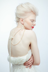 Image showing beautiful albino girl with red lips on white background