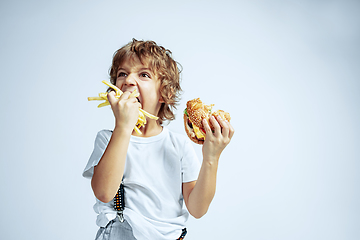 Image showing Pretty young boy in casual clothes on white studio background