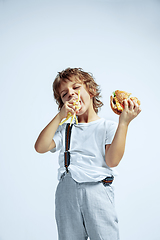 Image showing Pretty young boy in casual clothes on white studio background