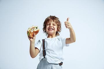 Image showing Pretty young boy in casual clothes on white studio background