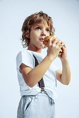 Image showing Pretty young boy in casual clothes on white studio background