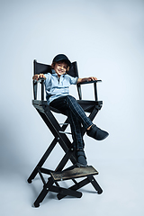 Image showing Pretty young boy in casual clothes on white studio background