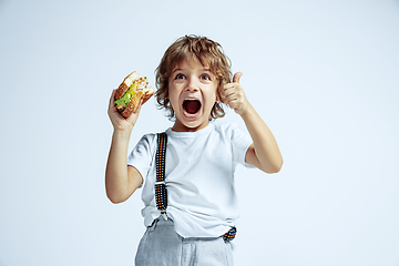 Image showing Pretty young boy in casual clothes on white studio background