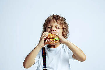 Image showing Pretty young boy in casual clothes on white studio background