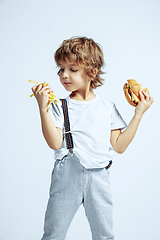 Image showing Pretty young boy in casual clothes on white studio background