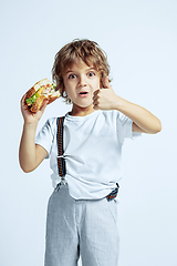 Image showing Pretty young boy in casual clothes on white studio background