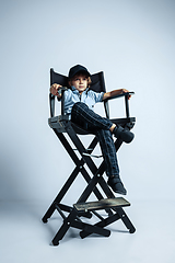 Image showing Pretty young boy in casual clothes on white studio background