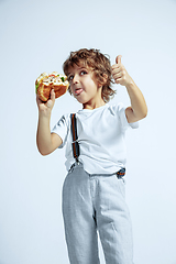 Image showing Pretty young boy in casual clothes on white studio background