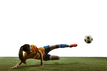 Image showing Female soccer player kicking ball at the stadium