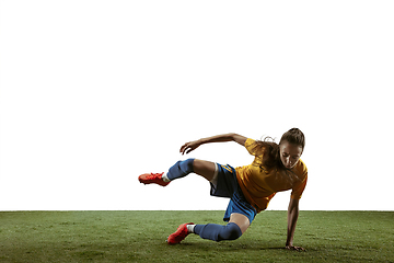 Image showing Female soccer player kicking ball at the stadium