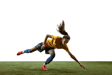 Image showing Female soccer player kicking ball at the stadium