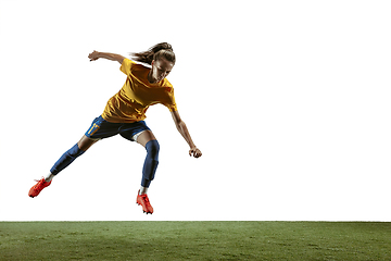 Image showing Female soccer player kicking ball at the stadium