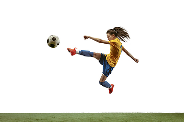 Image showing Female soccer player kicking ball at the stadium