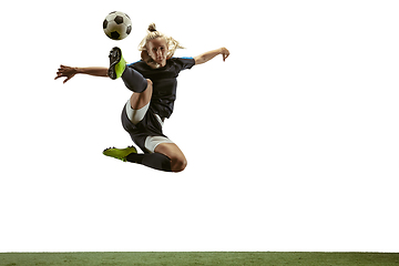 Image showing Female soccer player kicking ball at the stadium