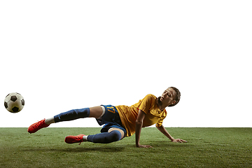 Image showing Female soccer player kicking ball at the stadium