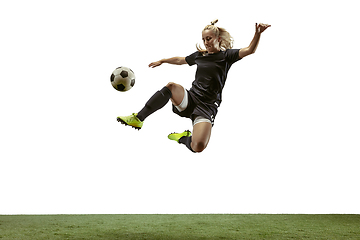 Image showing Female soccer player kicking ball at the stadium