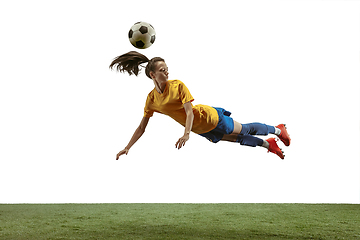 Image showing Female soccer player kicking ball at the stadium