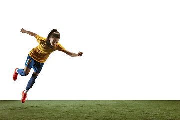 Image showing Female soccer player kicking ball at the stadium