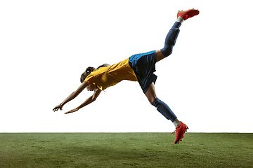 Image showing Female soccer player kicking ball at the stadium