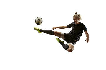 Image showing Female soccer player kicking ball at the stadium