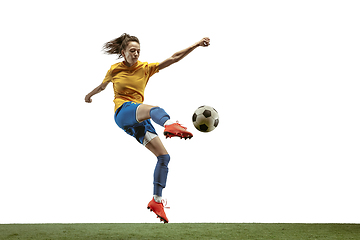 Image showing Female soccer player kicking ball at the stadium