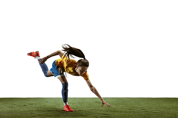 Image showing Female soccer player kicking ball at the stadium