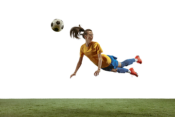 Image showing Female soccer player kicking ball at the stadium