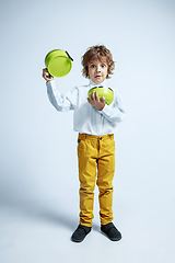 Image showing Pretty young boy in casual clothes on white studio background