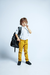 Image showing Pretty young boy in casual clothes on white studio background