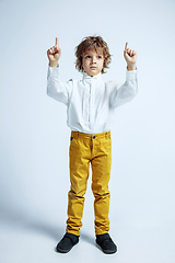 Image showing Pretty young boy in casual clothes on white studio background