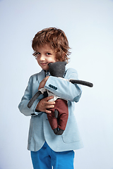 Image showing Pretty young boy in casual clothes on white studio background