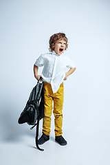 Image showing Pretty young boy in casual clothes on white studio background