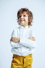 Image showing Pretty young boy in casual clothes on white studio background