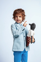 Image showing Pretty young boy in casual clothes on white studio background