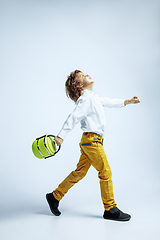 Image showing Pretty young boy in casual clothes on white studio background