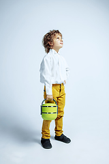 Image showing Pretty young boy in casual clothes on white studio background