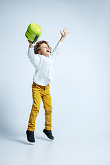 Image showing Pretty young boy in casual clothes on white studio background