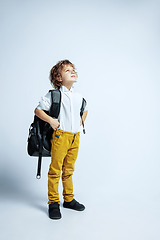 Image showing Pretty young boy in casual clothes on white studio background