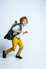 Image showing Pretty young boy in casual clothes on white studio background