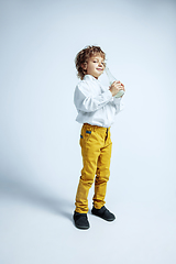 Image showing Pretty young boy in casual clothes on white studio background