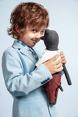 Image showing Pretty young boy in casual clothes on white studio background