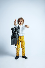 Image showing Pretty young boy in casual clothes on white studio background