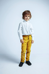 Image showing Pretty young boy in casual clothes on white studio background