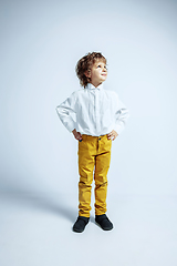 Image showing Pretty young boy in casual clothes on white studio background