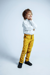 Image showing Pretty young boy in casual clothes on white studio background