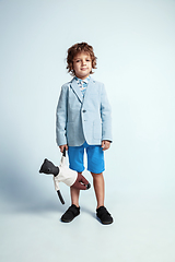 Image showing Pretty young boy in casual clothes on white studio background