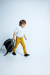 Image showing Pretty young boy in casual clothes on white studio background