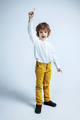 Image showing Pretty young boy in casual clothes on white studio background